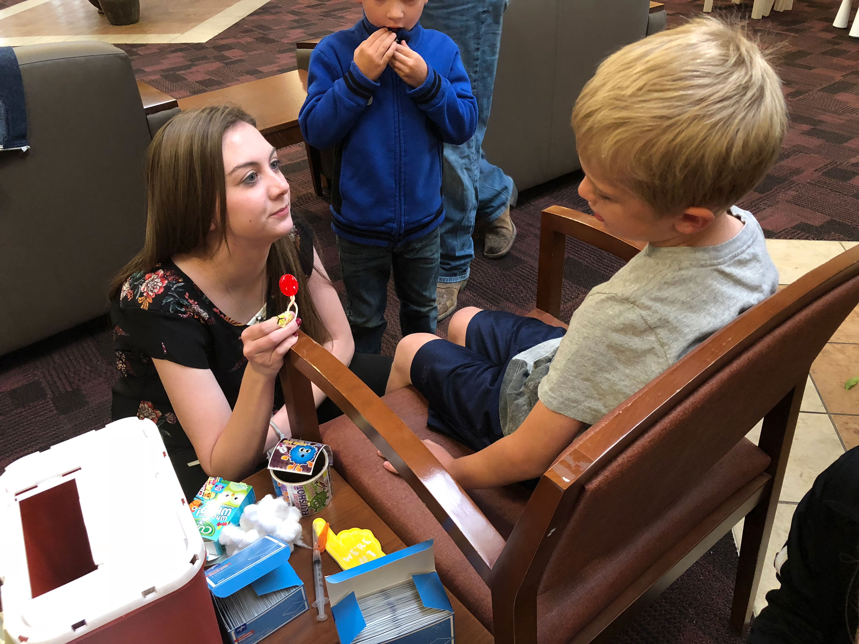 Rural Outreach Trip to Blanding 2018 student giving child a lollipop