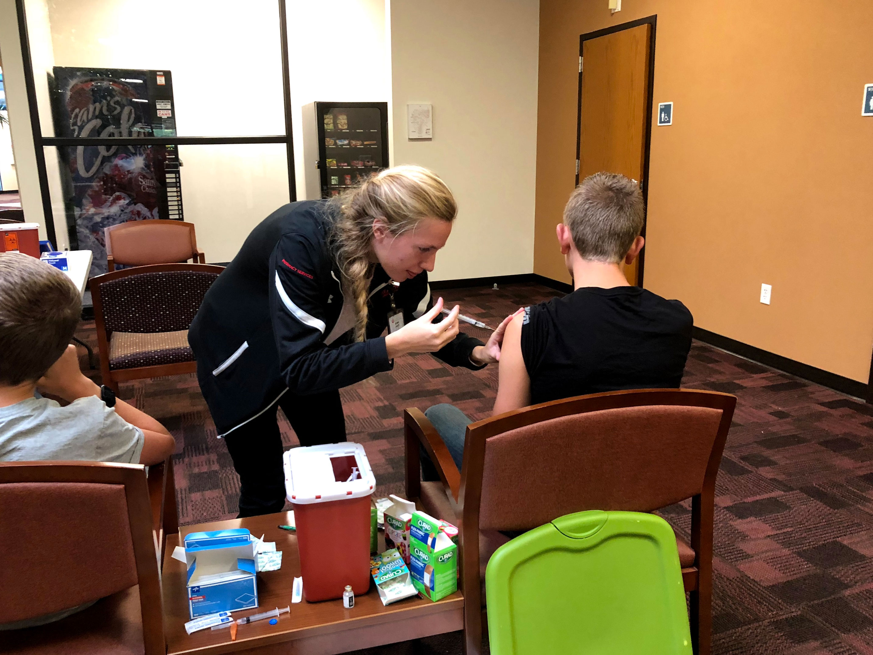 Rural Outreach Trip to Blanding 2018 student giving child a shot