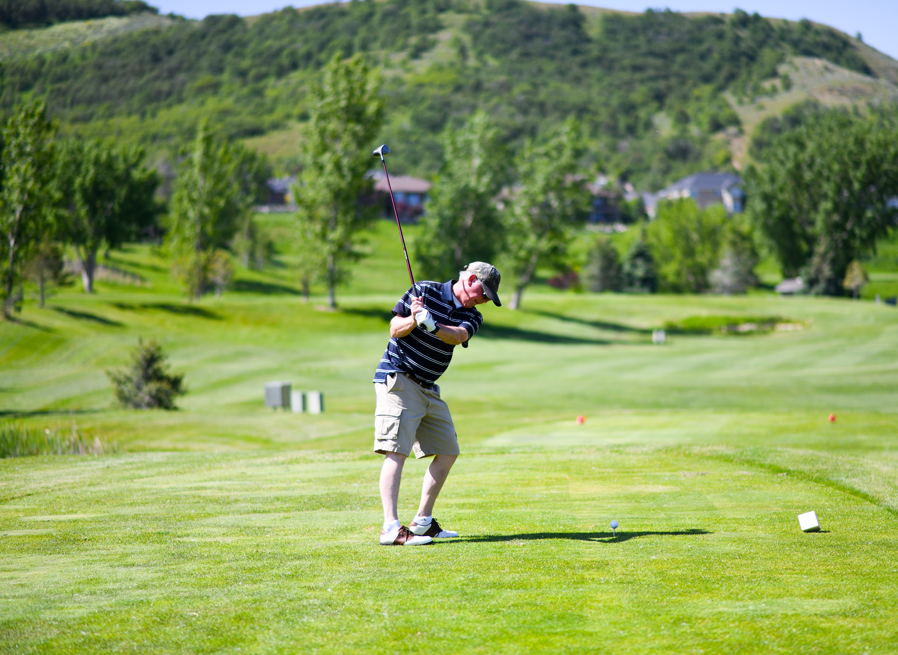 golfer hitting the golf ball on course