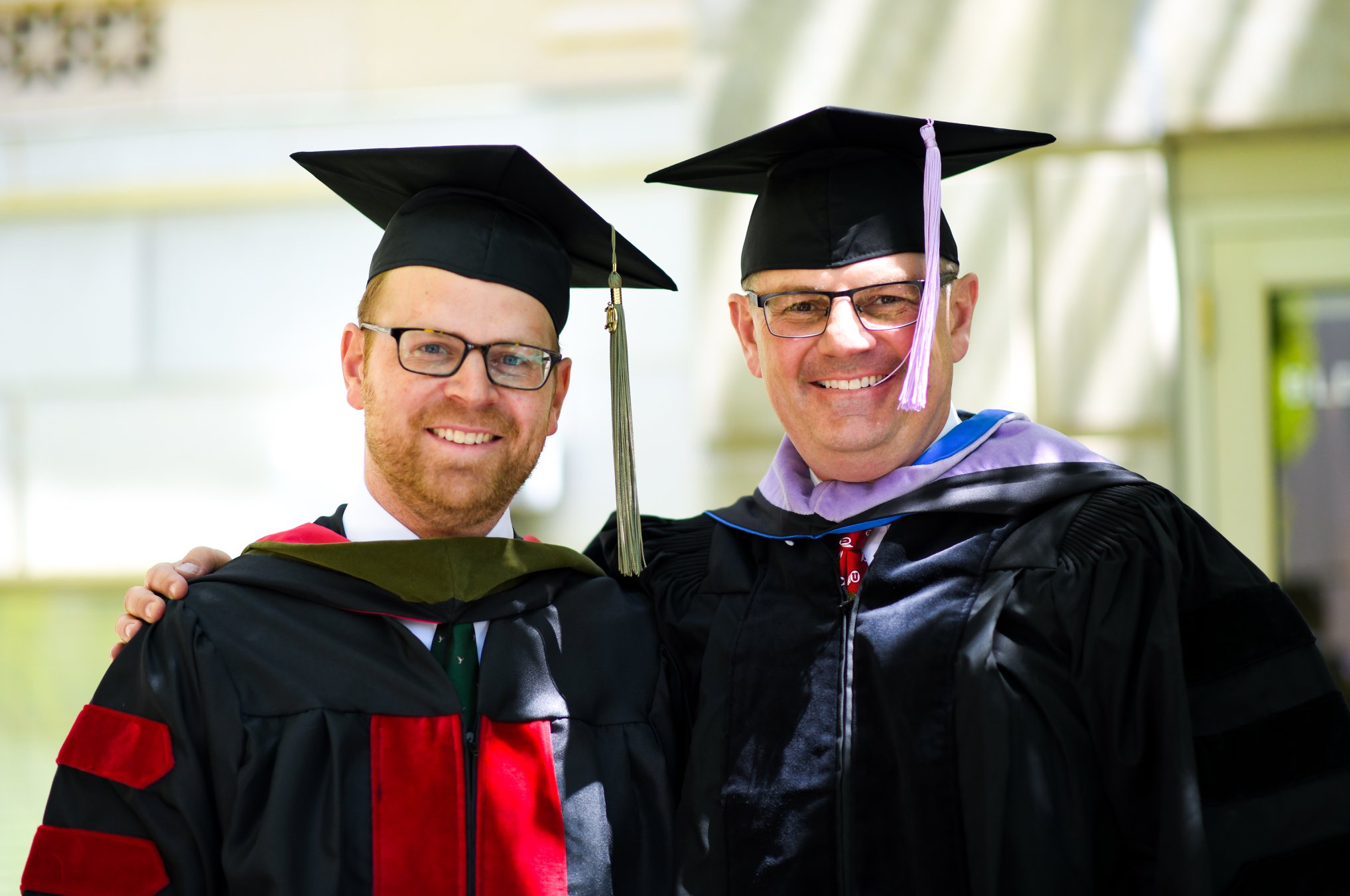 two men in graduation robes