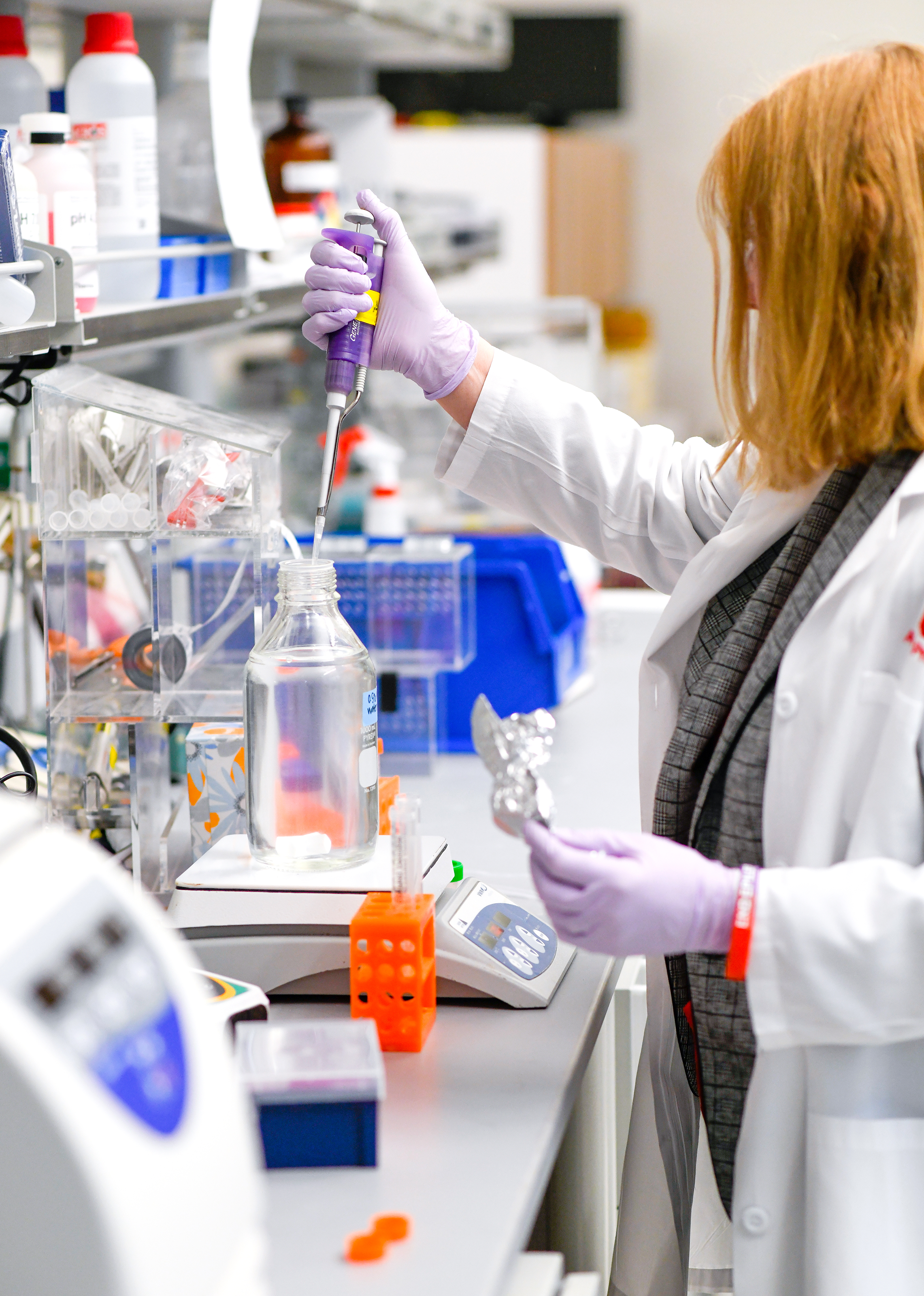 Woman in lab filling vials