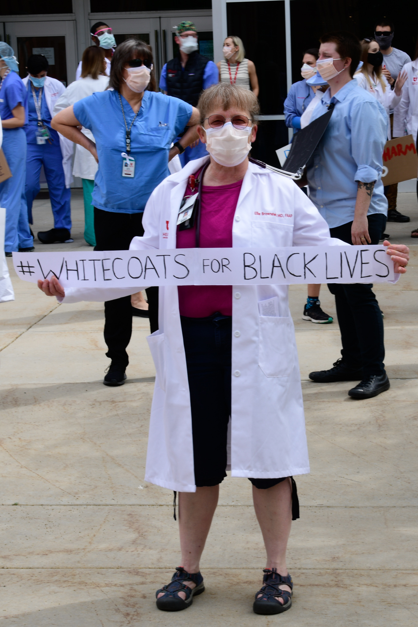 White Coats for Black Lives 4 Woman Holding Sign