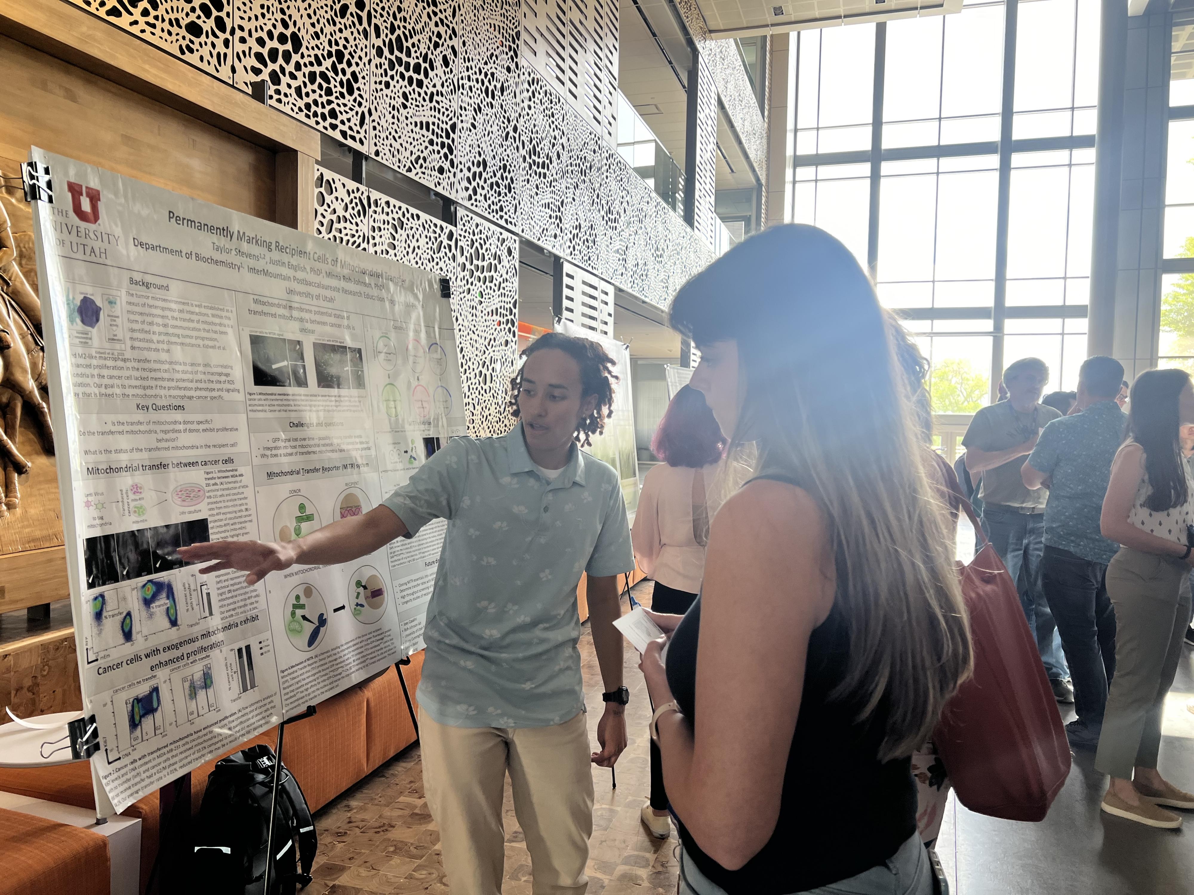 2 students in front of a poster, Skaggs Building
