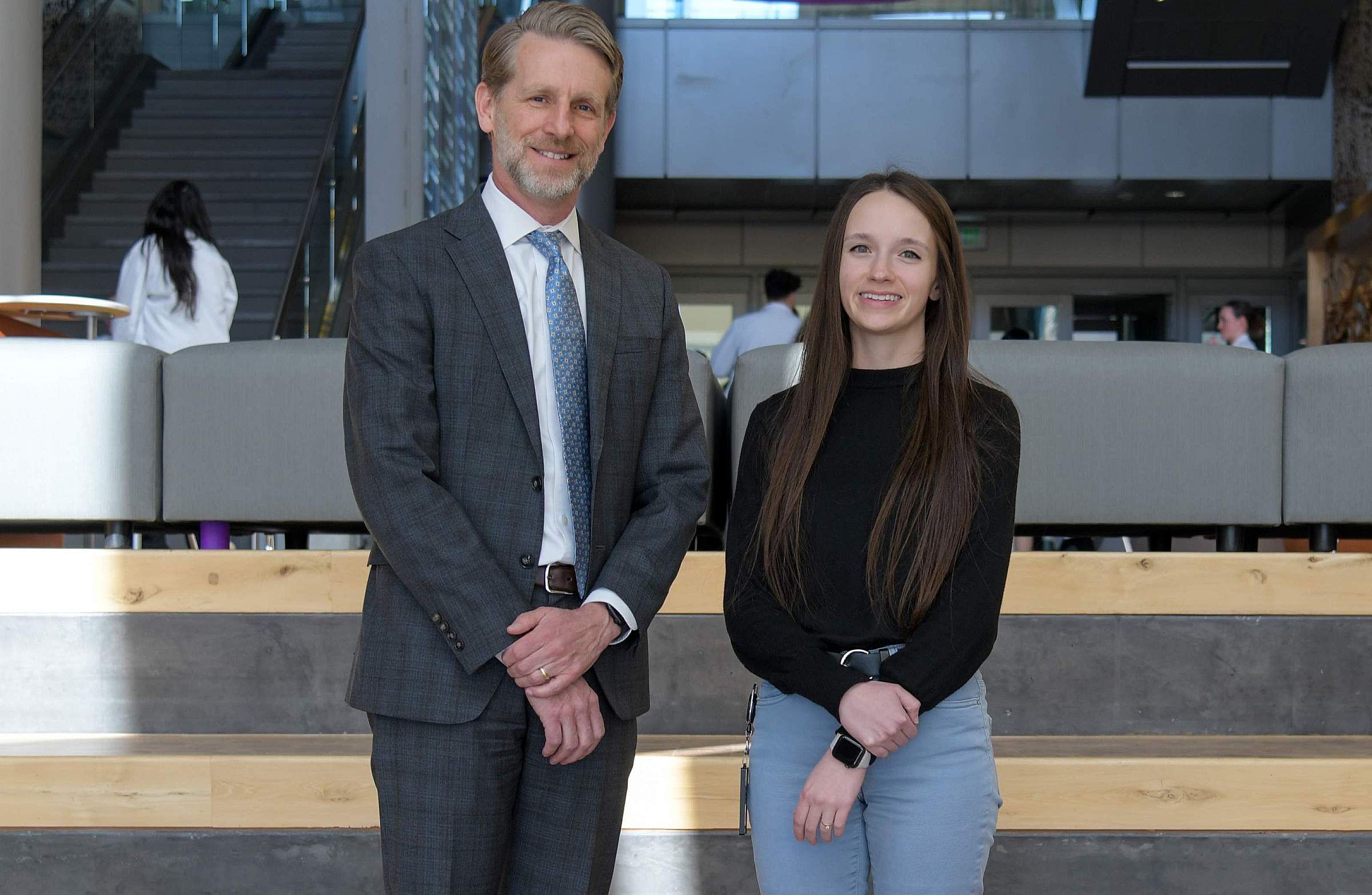 Randall T. Peterson, University of Utah College of Pharmacy Dean, poses with Emily Tippetts, PhD, in the school's atrium.