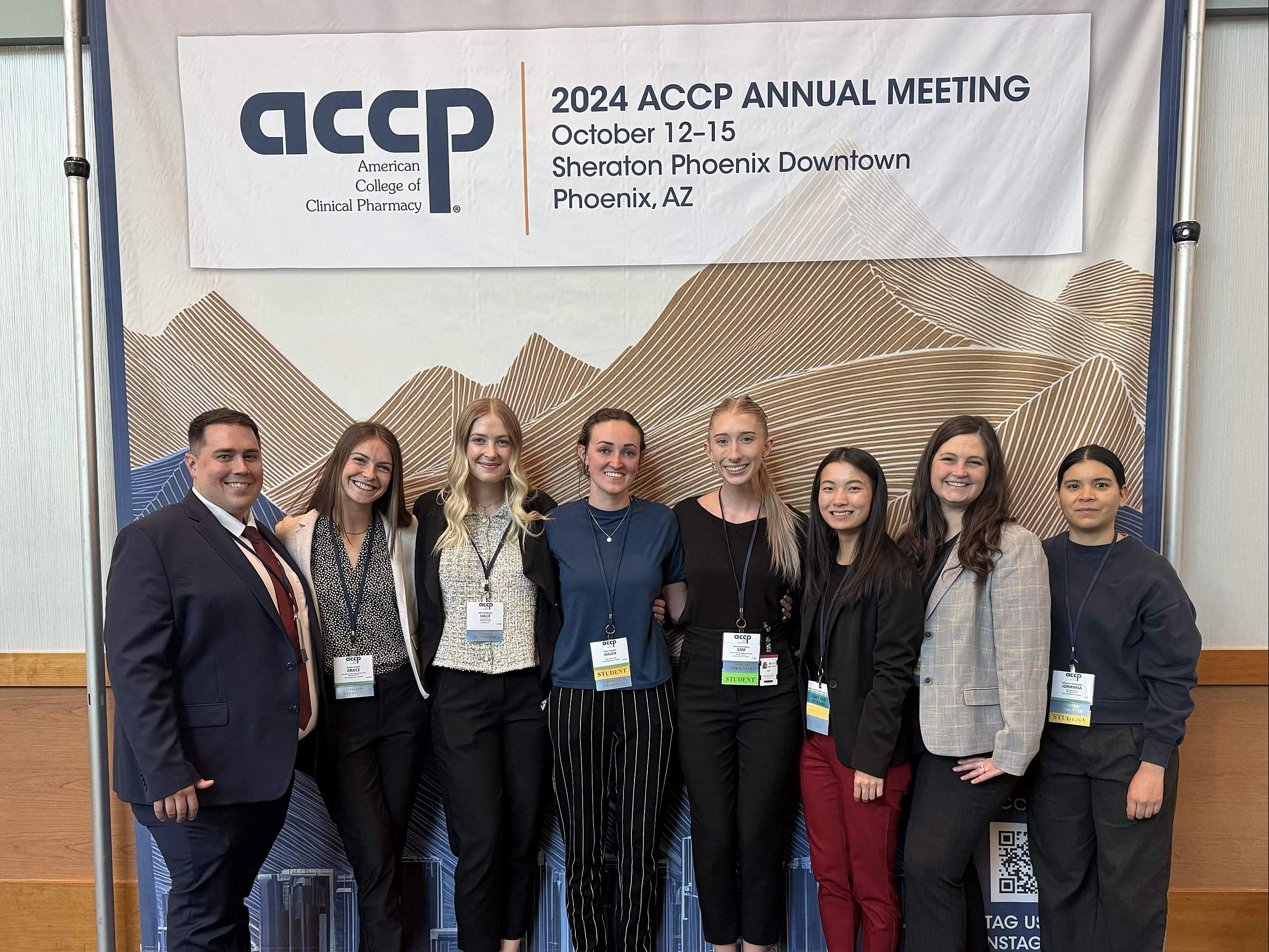 Students gather in front of 2024 ACCP Annual Meeting signage in Phoenix, Arizona.