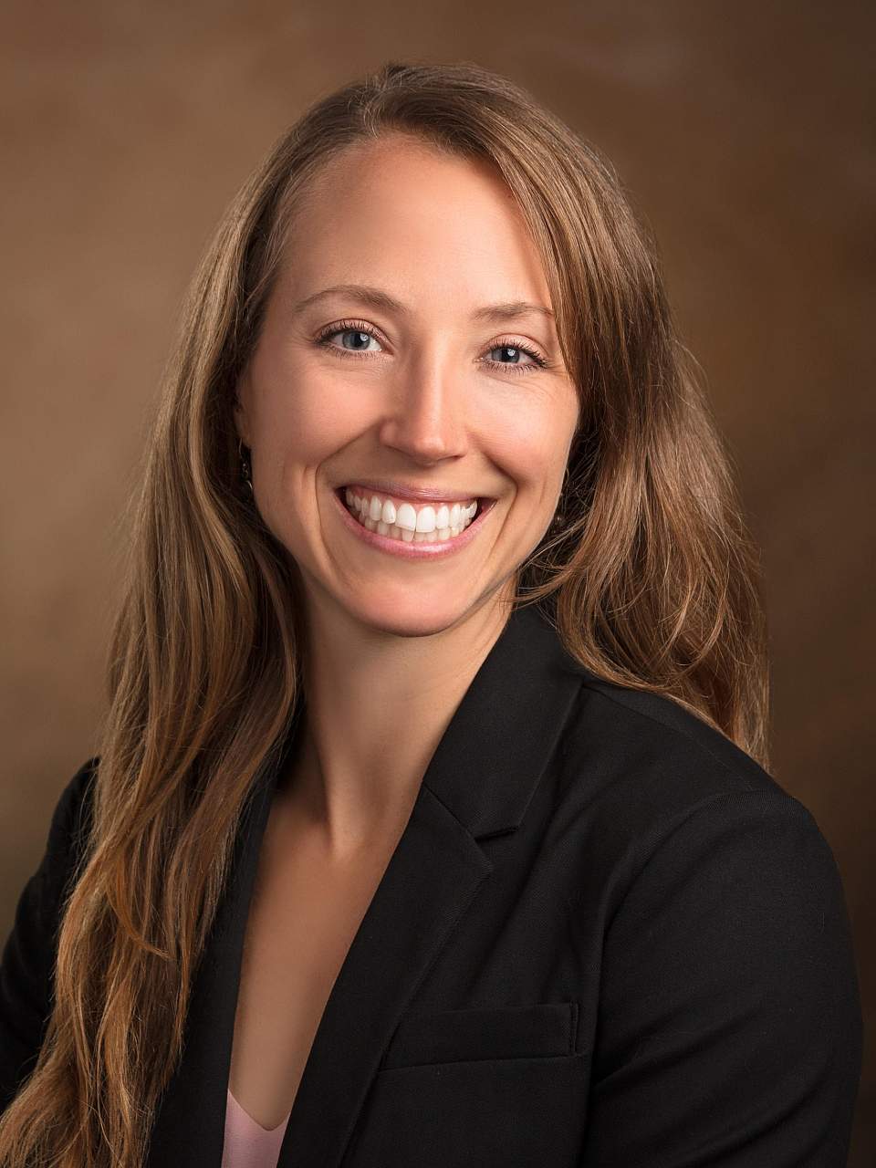 Dr. Abby Pulsipher Dr. Abby Pulsipher smiles for headshot in black sports jacket