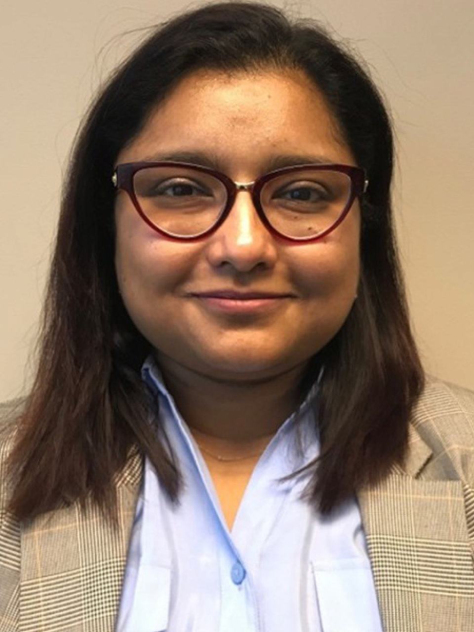 Dr. Farzana Alam, in a blue shirt and tan blazer