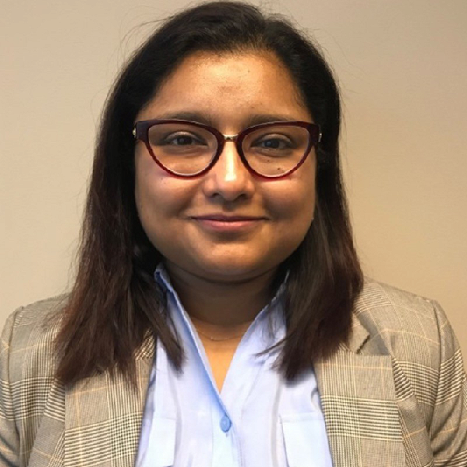 Dr. Farzana Alam, in a blue shirt and tan blazer