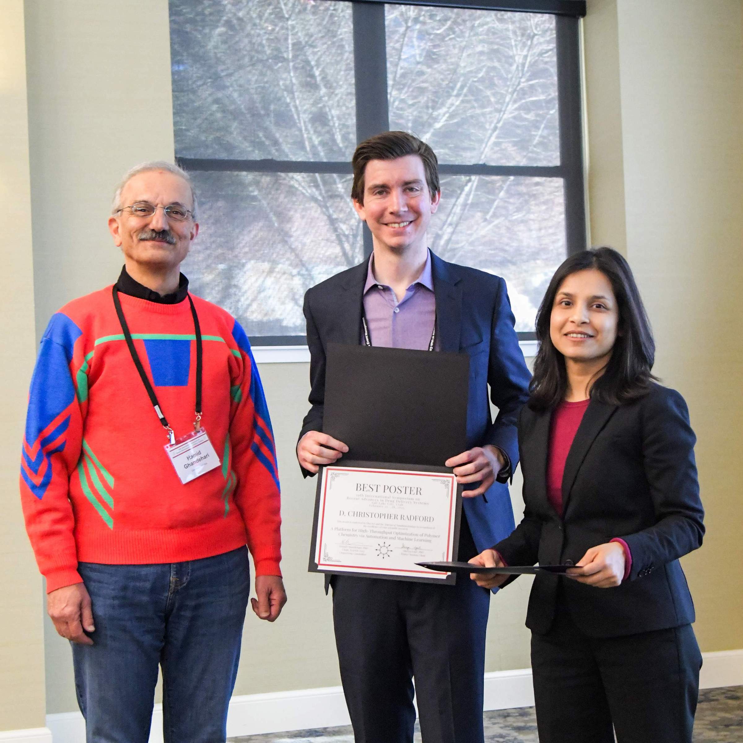 D. Christopher Radford (Center) receives a Best Poster award. (February 28, 2025)