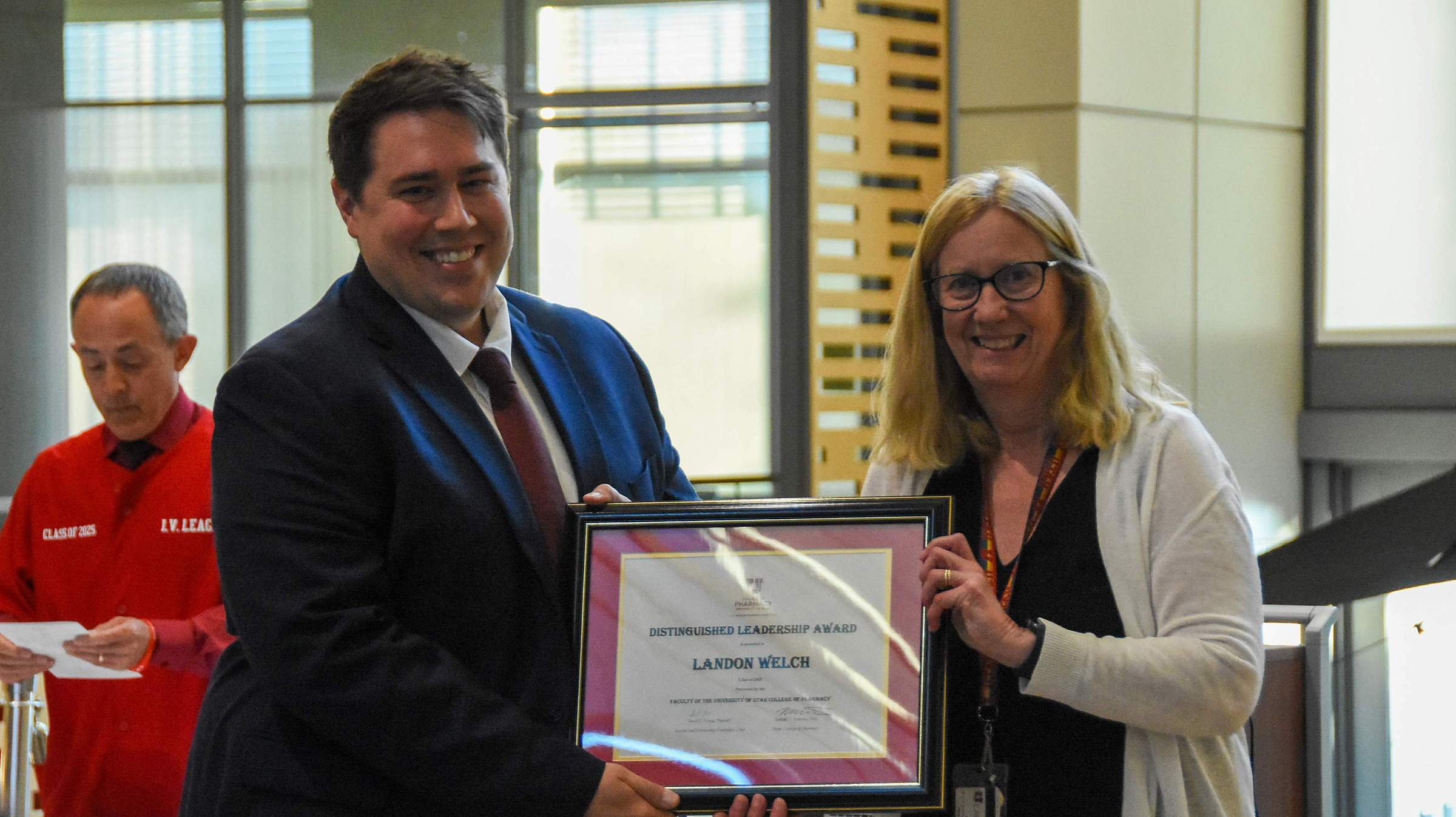 Landon Welch, PharmD, receives his Distinguished Leadership Award from Karen Wilcox, PhD. (May 7, 2025)